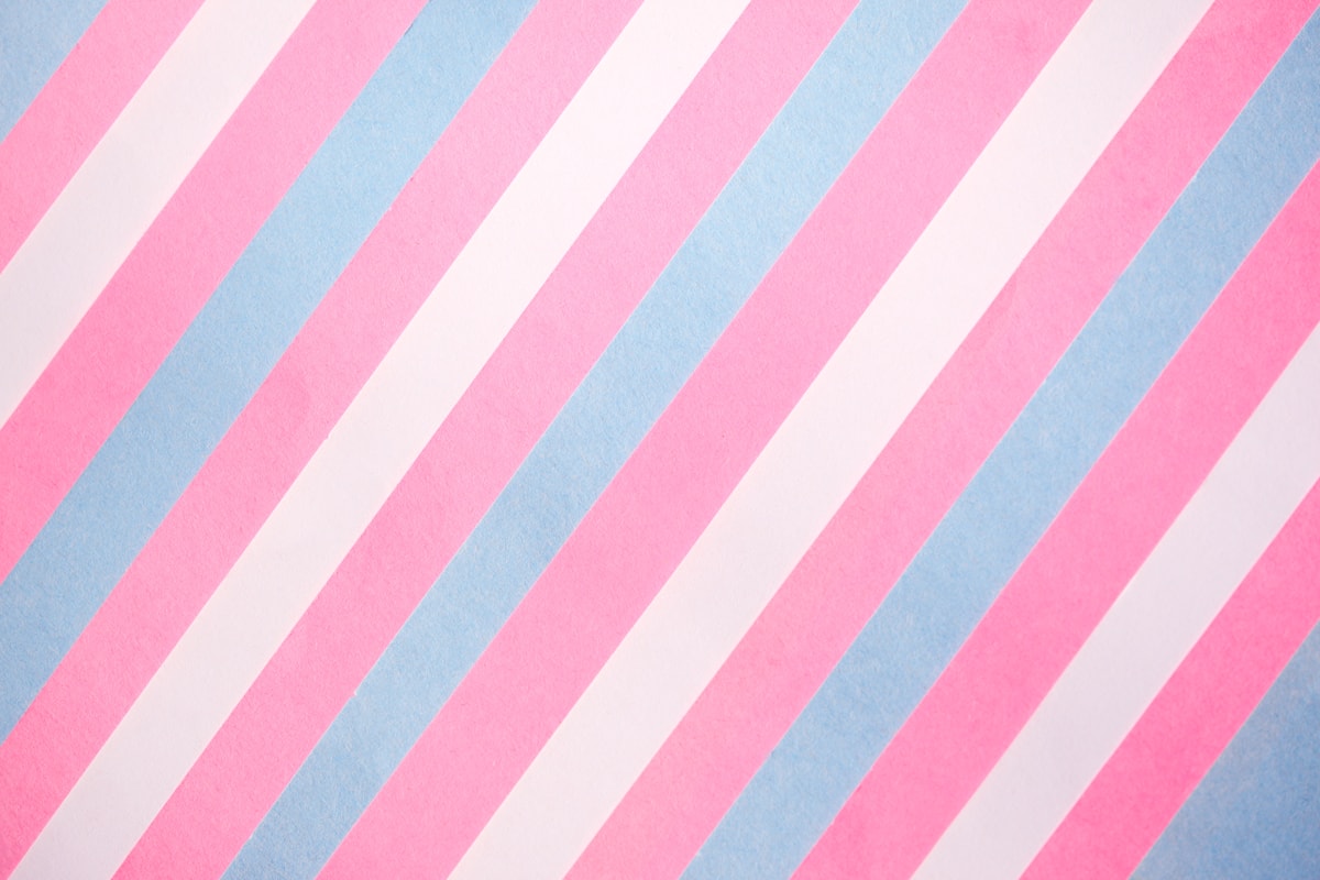 Close-up of soft blue, pink, and white striped textile — the colors of the transgender pride flag